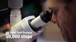 A man looking into microscope, with texts located on the bottom left corner reading as “HP Total Test Process” and “50,000 steps”
